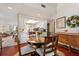 Dining area with wooden table and view into kitchen and living room at 6004 Greenleaf Cir, Winter Haven, FL 33884