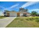 Single-story home with stone accents and landscaped yard at 6004 Greenleaf Cir, Winter Haven, FL 33884