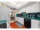 Kitchen features white cabinets, green countertops, and a dishwasher at 6004 Greenleaf Cir, Winter Haven, FL 33884