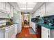 Galley style kitchen, white appliances, green countertops at 6004 Greenleaf Cir, Winter Haven, FL 33884