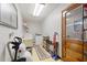 Well-equipped laundry room with washer, dryer, and storage shelves at 6004 Greenleaf Cir, Winter Haven, FL 33884