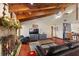 Living room with stone fireplace, wood beams, and flat screen TV at 6004 Greenleaf Cir, Winter Haven, FL 33884