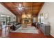Spacious living room with a stone fireplace and wood beam ceiling at 6004 Greenleaf Cir, Winter Haven, FL 33884