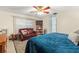 Main bedroom with king-size bed, sitting area, and built-in shelving at 6004 Greenleaf Cir, Winter Haven, FL 33884