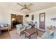 Relaxing patio with wicker furniture and ceiling fan at 6004 Greenleaf Cir, Winter Haven, FL 33884