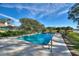 Inviting rectangular pool with a lake view at 6004 Greenleaf Cir, Winter Haven, FL 33884