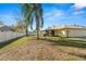 Spacious backyard with mature palm trees and a pergola at 7101 Scenic Pl, Lakeland, FL 33810