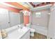 Bathroom with white vanity, bathtub, and decorative wallpaper at 7101 Scenic Pl, Lakeland, FL 33810