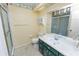 Bathroom with shower and green vanity at 7101 Scenic Pl, Lakeland, FL 33810