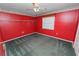 Red bedroom with dark green carpet and ceiling fan at 7101 Scenic Pl, Lakeland, FL 33810