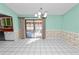 Dining area with floral wallpaper, tiled floors, and patio access at 7101 Scenic Pl, Lakeland, FL 33810