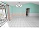 Dining room with floral wallpaper, tiled floors, and access to a patio at 7101 Scenic Pl, Lakeland, FL 33810