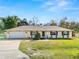 Single-story house with attached garage, brick accents, and a well-maintained lawn at 7101 Scenic Pl, Lakeland, FL 33810