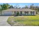 Single story home with attached garage and manicured lawn at 7101 Scenic Pl, Lakeland, FL 33810