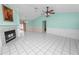 Spacious living room with light teal walls, tiled floors, and a fireplace at 7101 Scenic Pl, Lakeland, FL 33810