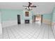 Spacious living room with light teal walls, tiled floors, and a fireplace at 7101 Scenic Pl, Lakeland, FL 33810