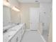 Double vanity bathroom with hexagon floor tile and a walk-in shower at 715 Teaberry Trl, Polk City, FL 33868
