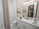 Bathroom with white vanity, shower, and hexagon tile floors at 715 Teaberry Trl, Polk City, FL 33868