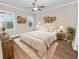 Spacious bedroom with wood floors and neutral decor at 715 Teaberry Trl, Polk City, FL 33868