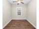 Simple bedroom with wood floors and a large window at 715 Teaberry Trl, Polk City, FL 33868