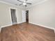 Bright bedroom featuring wood flooring and an ensuite bathroom at 715 Teaberry Trl, Polk City, FL 33868