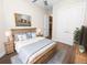 Charming bedroom with wood flooring and a rustic bed frame at 715 Teaberry Trl, Polk City, FL 33868