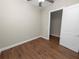 Bright bedroom with wood-look floors and an attached closet at 715 Teaberry Trl, Polk City, FL 33868