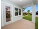 Covered patio with door leading inside and a view of the backyard at 715 Teaberry Trl, Polk City, FL 33868