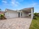 Single-story home with attached garage and paver driveway at 715 Teaberry Trl, Polk City, FL 33868