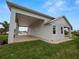 Exterior view of the house showcasing a covered patio at 715 Teaberry Trl, Polk City, FL 33868