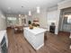 Bright kitchen with island, stainless steel appliances, and hardwood floors at 715 Teaberry Trl, Polk City, FL 33868