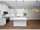 White kitchen with granite countertops and stainless steel appliances at 715 Teaberry Trl, Polk City, FL 33868