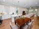 Open concept kitchen with white cabinets, island, and hardwood floors at 715 Teaberry Trl, Polk City, FL 33868