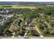 Aerial view showcasing a house nestled in a wooded area with a long driveway at 748 Mcclellan Rd, Frostproof, FL 33843