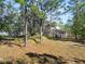 House's backyard showing a large grassy area with mature trees and a shed at 748 Mcclellan Rd, Frostproof, FL 33843