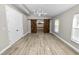 Bright bedroom with wood-look floors and barn doors at 748 Mcclellan Rd, Frostproof, FL 33843
