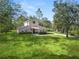 Tan house with stone accents and a spacious lawn at 748 Mcclellan Rd, Frostproof, FL 33843