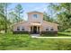 Two-story house with stone accents and a landscaped lawn at 748 Mcclellan Rd, Frostproof, FL 33843