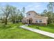 Two-story house with stone accents and a landscaped lawn at 748 Mcclellan Rd, Frostproof, FL 33843