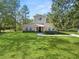 Two-story house with stone accents and a spacious lawn at 748 Mcclellan Rd, Frostproof, FL 33843