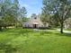 Two-story house with stone accents and a large grassy yard at 748 Mcclellan Rd, Frostproof, FL 33843