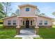 Two-story house with stone accents and a landscaped lawn at 748 Mcclellan Rd, Frostproof, FL 33843