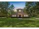 Two-story house with stone accents and a large grassy yard at 748 Mcclellan Rd, Frostproof, FL 33843