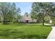Two-story house with stone accents and a large grassy yard at 748 Mcclellan Rd, Frostproof, FL 33843