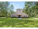 Two-story house with stone accents and a large grassy yard at 748 Mcclellan Rd, Frostproof, FL 33843