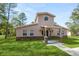 Two-story house with stone accents and a landscaped lawn at 748 Mcclellan Rd, Frostproof, FL 33843