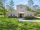 Two-story house with stone accents and a spacious lawn at 748 Mcclellan Rd, Frostproof, FL 33843
