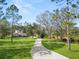 Two-story house with a long driveway, surrounded by lush green grass and trees at 748 Mcclellan Rd, Frostproof, FL 33843