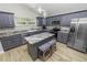 Modern kitchen with gray cabinets, granite counters, and island at 748 Mcclellan Rd, Frostproof, FL 33843