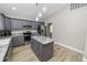 Modern kitchen with gray cabinets, granite counters, and island at 748 Mcclellan Rd, Frostproof, FL 33843
